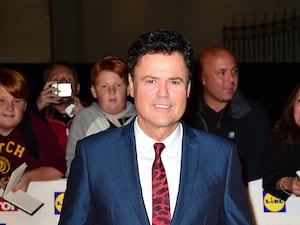 Donny Osmond smiling at an awards ceremony