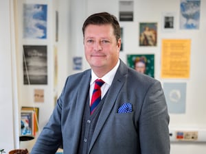 Handout photo of Sir Martyn Oliver smiling, wearing suit and tie