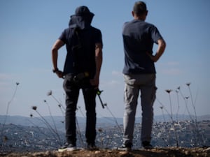 Two armed Israelis looking into Lebanon