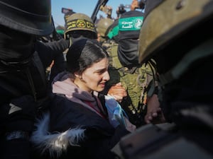 Captive Arbel Yehoud looks distressed as she is led to be released