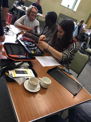 The repair of an electrical item at a repair cafe.