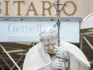 A statue of Pope John Paul II in front of the hospital