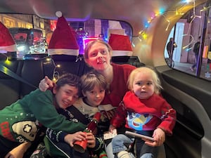 Alfie with mum Kathleen and his brothers Teddie and Bobby in the black cab