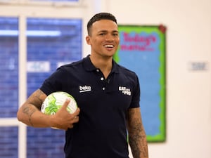 Jermaine Jenas holding a football under his right arm