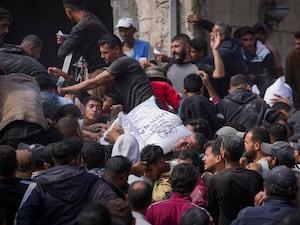 Palestinians gather to receive bags of flour distributed by UNRWA