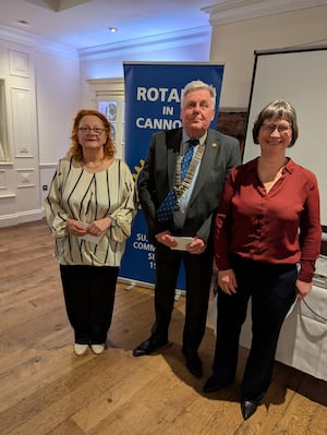 Vicki from Cannock foodbank receiving a cheque from SI Cannock Tracey Stokes and Rotary President David Marklew