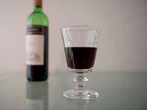 A bottle and glass of red wine