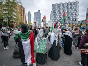 People wearing and waving Palestinian flags