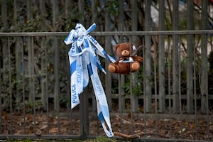 A teddy bear and flowers were left at the scene following the crash