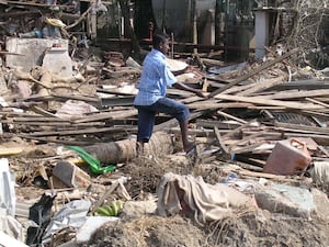 A person clears away debris following the 2004 tsunami, in Galle, southern Sri Lanka