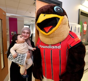 Walsall FC players and mascot Swift visited the town's Manor Hospital to meet staff and patients and give presents out for Christmas.
Yahya Haval, aged seven months meets Swifty.