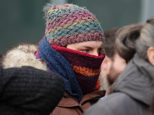 Dr Beth Upton with her face covered by a scarf