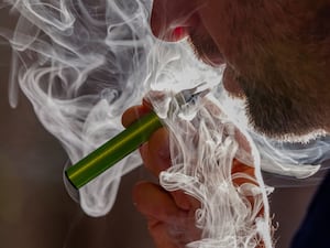 A man vapes on a disposable electronic cigarette in Brussels