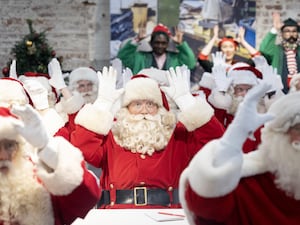 Trainee Santas wave their hands