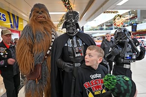 Darth Vader and Chewbacca use the force as people pose for photos