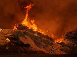 A firefighter battles the Palisades Fire