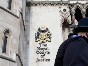 Police officers outside the Royal Courts of Justice (PA)