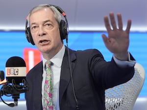 Nigel Farage raises his hand as he speaks during a phone-in on LBC.