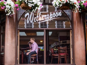 A man drinking at the Rochester Castle Wetherspoon pub in Stoke Newington, north London