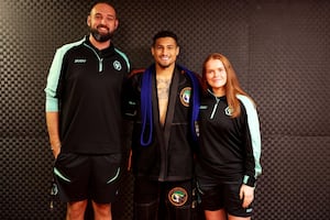 Wolves Foundation staff Matt Campbell and Grace Whiston with midfielder Joao Gomes.