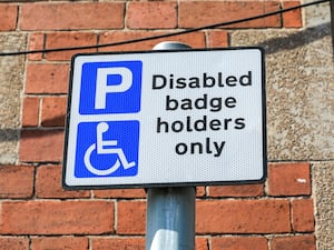 A parking sign saying 'disabled badge holders only'