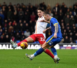 Walsall midfielder Jamie Jellis challenging for the ball.