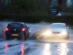 Motorists drive through standing water in Upton upon Severn, Worcestershire.