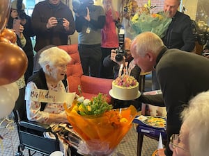 Steve Bull, ex-striker for Wolverhampton Wanders, presenting Joan Davies with a cake for her 100th birthday