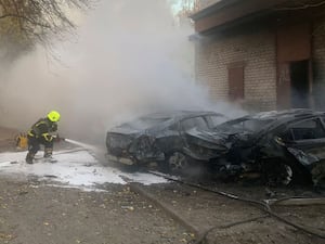 Emergency services personnel work to extinguish a fire following a Russian rocket attack in Poltava region, Ukraine