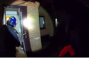 West Midlands Police, using a chainsaw on the door of a property in Derrydown Road, Birmingham. 