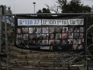 A poster shows portraits of Bibas family, top row from second left: Yarden, Shiri, and their sons Ariel and Kfir, who were kidnapped to Gaza on October 7 2023