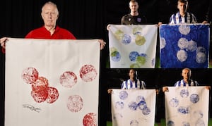 Football players have hit footballs against canvases to create the artwork