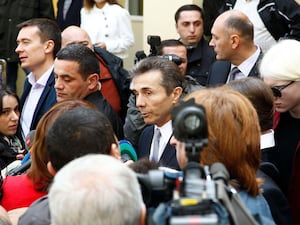 Bidzina Ivanishvili, centre, leader of the Georgian Dream party, surrounded by people and cameras