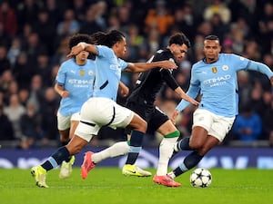 Nathan Ake, left, and Manuel Akanji challenge Feyenoord's Julian Carranza