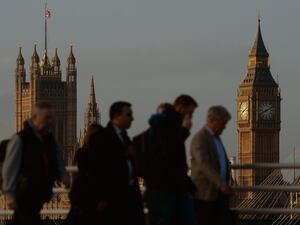 Commuters in London with Big Ben and the Houses of Parliament in the background