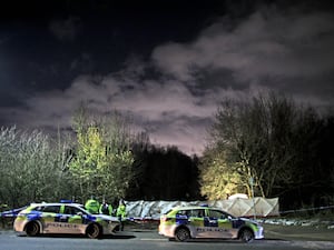 Police vehicles an tenting at dark field