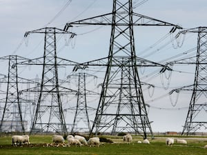 Overhead power cables from the Dungeness Nuclear Power Station stretching across the Kent countryside