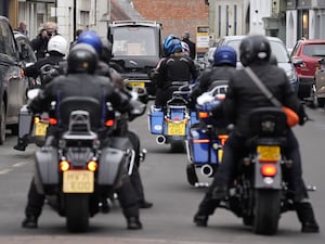 Motorbikes following the hearse carrying Johnnie Walker's coffin at his funeral