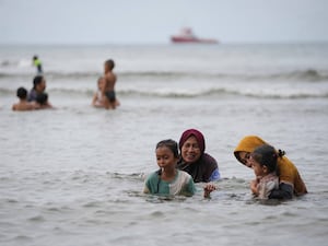 People play in the water at Ulee Lheue beach which was one of the areas hardest hit by Indian Ocean tsunami in 2004, in Banda Aceh