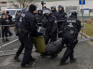 Police remove a protestor from the street