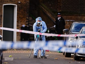 A police forensic officer at the scene on Southern Grove in Ladbroke Grove, west London, after an eight-year-old girl was seriously injured when she was shot