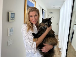 Margo Neas hugs her long-haired cat Mittens