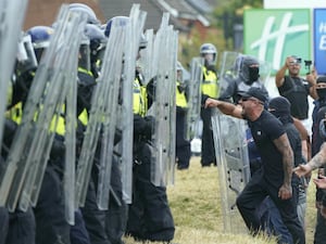 Police fend off demonstrators using shields during disorder