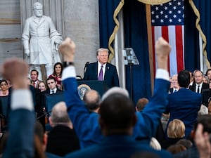 Attendees cheer as President Donald Trump speaks after taking the oath of office during the 60th Presidential Inauguration in the Rotunda of the US Capitol in Washington