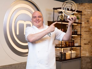 Dan Merriman posing with his Masterchef trophy