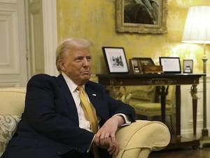 Donald Trump on a sofa in an opulent office