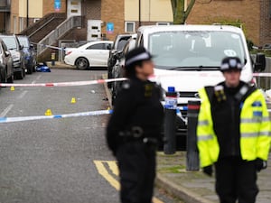 Police officers at the scene on Gifford Road, Brent, after a woman was killed in a shooting