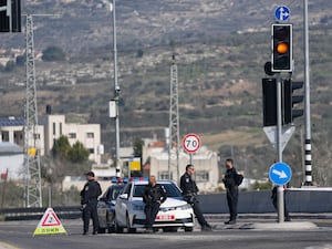 Policemen block a main road