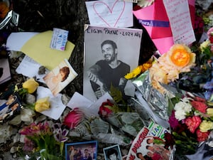 A picture of former One Direction singer Liam Payne is surrounded with flowers and candles as part of a makeshift memorial outside the hotel where he fell from a balcony to his death, in Buenos Aires, Argentina