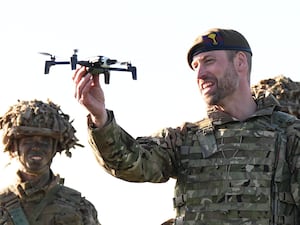 The Prince of Wales holding a drone